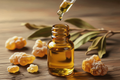 oil dropper dropping essential oil into an amber colored bottle with frankincense in the background